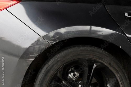 Scratched car fender damage close-up