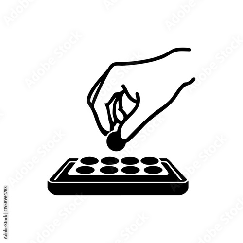 Minimalist black vector of a hand picking candy from a tray, symbolizing choice, selection, and indulgence in sweets.
