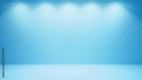Blue studio backdrop with overhead spotlights illuminating a light blue wall and floor creating a clean and simple background