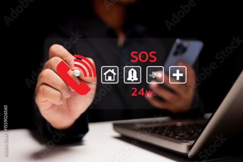 A person uses a smartphone and laptop while interacting with a virtual SOS emergency call interface showing icons for home, alert, ambulance, and medical assistance.