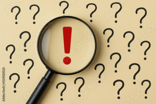 A magnifying glass focuses on a red exclamation mark among scattered question marks symbolizing clarity and decisive insight in uncertainty