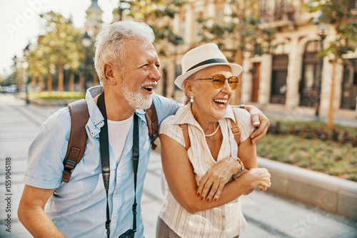 Happy senior couple sightseeing and laughing together in the city