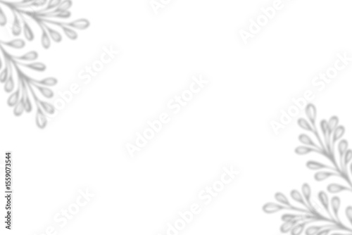 shadow Two corners of the image feature stylized silver floral or leaf-like designs against a white background.