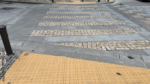 Konstfotografi Textured cobblestone crosswalk, tactile paving whispers urban movement, World Ar