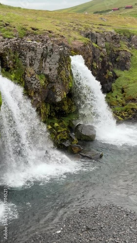 Kirkjufellsfoss Waterfall in Iceland flowing over mossy lava rocks. One of the country’s most iconic waterfalls, located near the famous Kirkjufell mountain from Game of Thrones.