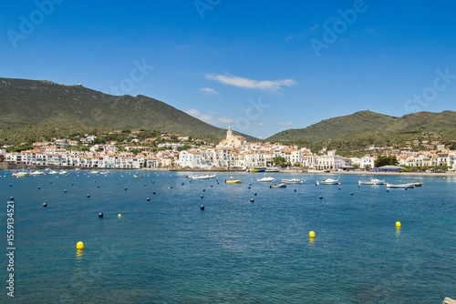 Charming Cadaqués, with small boats, white houses and vibrant blue sky, showcasing the historic Mediterranean coastal town’s beauty and traditional architecture