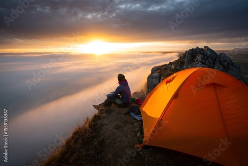 Silhouette of a man on a mountain at sunset overlooking the ocean