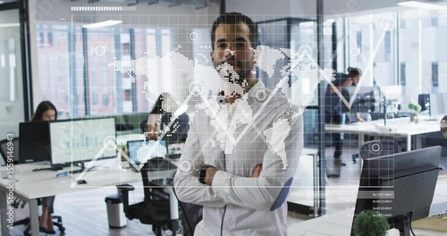 Man entering open-plan office while activating world map and markers linking pulsing business chart