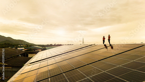 technician installs a large photovoltaic system on an industrial rooftop. ESG investment, and the future of sustainable technology powered by AI energy management and next generation solar cells.