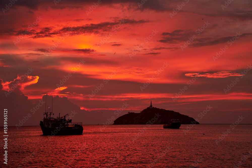 Fototapeta premium Fiery Sunset Trip with Boats and Island Silhouette (2)