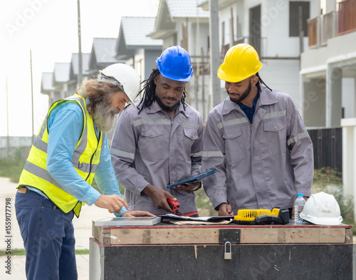 Professional architect and foreman wear head hat talk meeting safety work team check inspection tablet document ergy sorlar panels improvement project plan design home building in construction site.