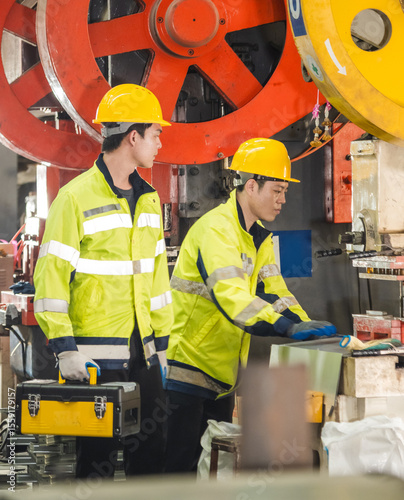 Leader manager talk work order staff male engineer technician team hard hat and uniform safety vest hand holding tool maintenance inspection check heavy machine technology produc in industry factory