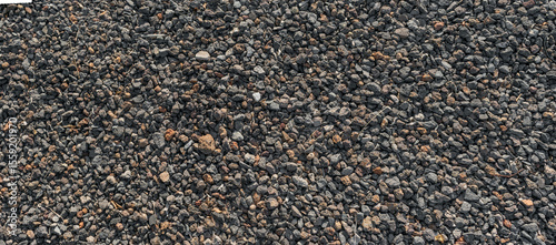 Texture of volcanic gravel ground with black stones and rough surface