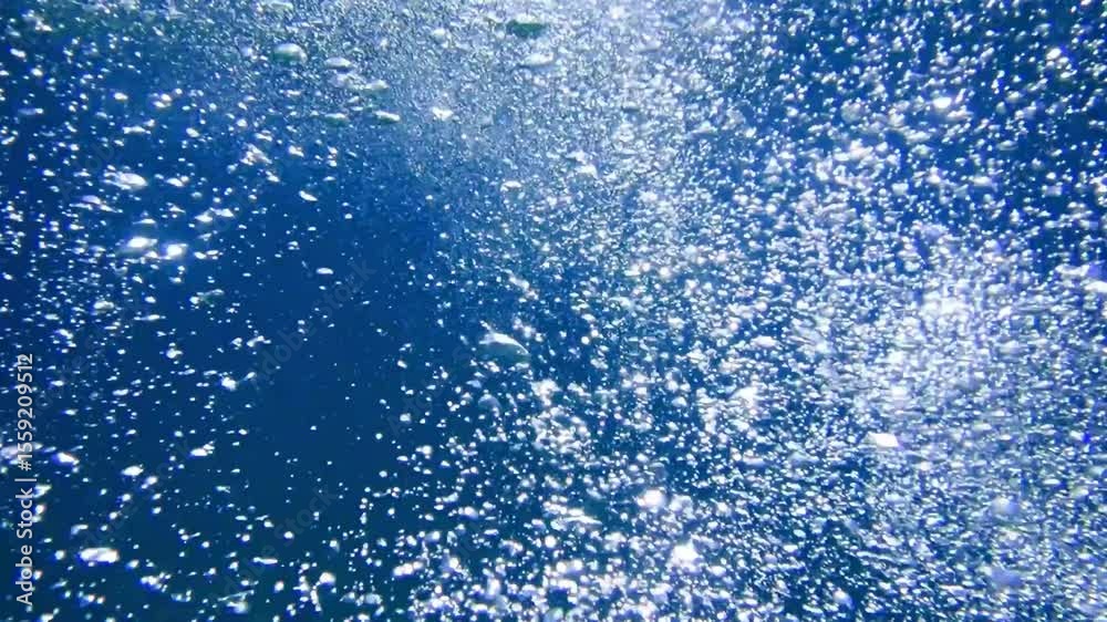 Air bubbles, Slow motion footage showcasing air bubbles gracefully ascending from the ocean floor to the water's surface,  Ideal for an abstract and serene natural background. underwater bubbles, sea.
