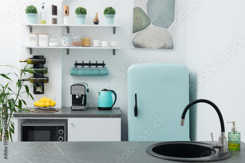 Modern kitchen with retro fridge and sleek appliances featuring functional design elements photo
