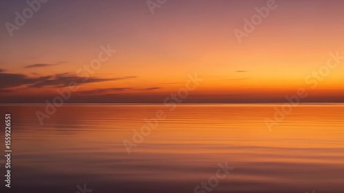 Sunset over a calm body of water