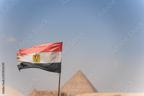 Photos Egyptian flag waving with pyramid of giza in background