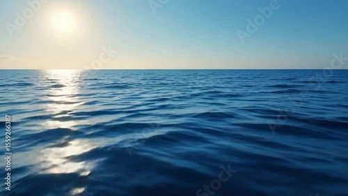 Beautiful ocean waves shimmering under the bright sun on a clear day