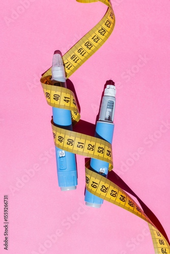 Flat lay photo of injectable medicine for diabetes. Bright modern background representing pharmaceutical therapy. Two injectors dosing pens for subcutaneous injection of antidiabetic medication