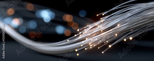 Close-up of glowing fiber optic cables in dark background with bokeh effect