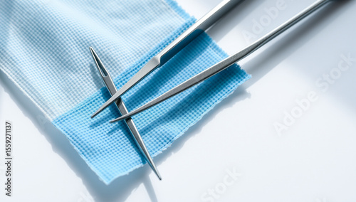 medical tweezers and gauze on sterile surface