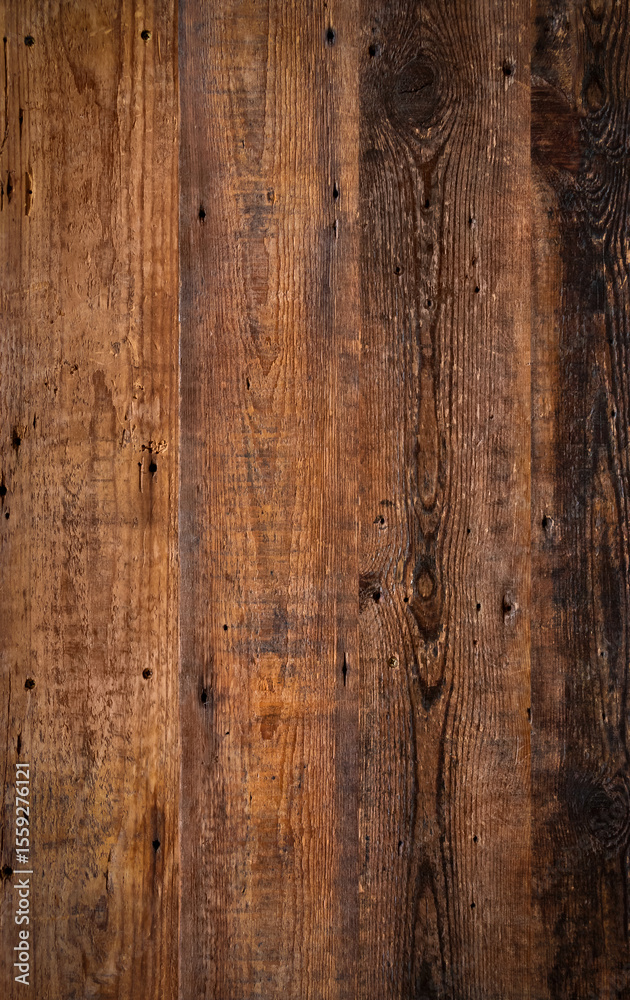 Obraz premium Brown wooden background texture highlighting the wood grain. Natural rustic backdrop depicting a surface comprising of slats of lumber.