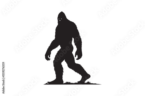 Silhouette of a hairy bigfoot creature walking on grassy ground