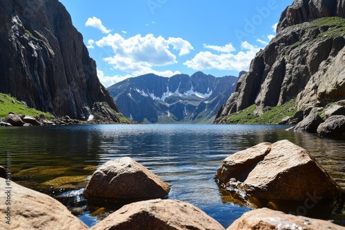 Stunning Mountain Lake Surrounded by Cliffs and Greenery in Bright Sunlight