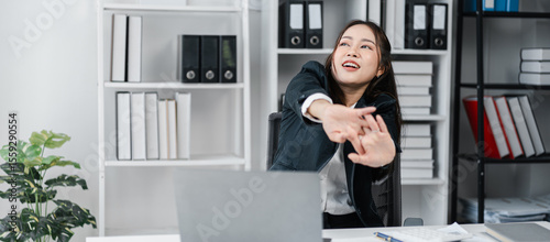 Relaxing Asian Business Woman Stretching Her Arms After Working At Her Laptop In Modern Office Stock Photo For Commercial Use And Digital Marketing