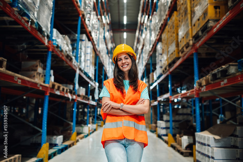 Wallpaper Mural Smiling warehouse worker wearing hardhat and safety vest posing with crossed arms Torontodigital.ca