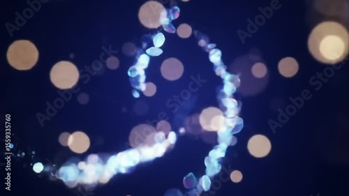 Abstract rotating double helix of iridescent crystal particles with golden bokeh lights on a blue background seamless loop animation.