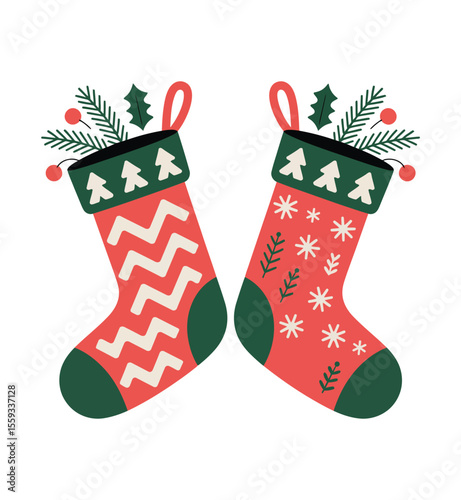 Two festive christmas stockings filled with pine branches and berries isolated on white background