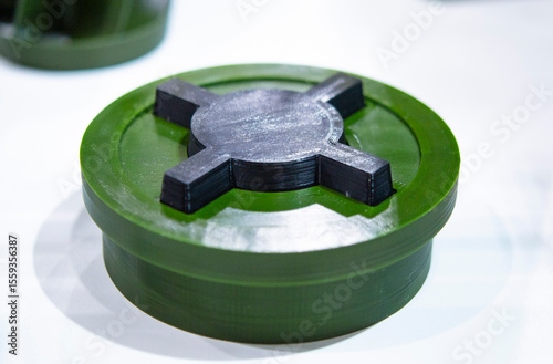 Anti-personnel high explosive mine printed on 3D printer. Mine created on 3D printer from molten plastic. Prototype of ammunition printed on 3D printer. Innovation modern new 3d printing technology