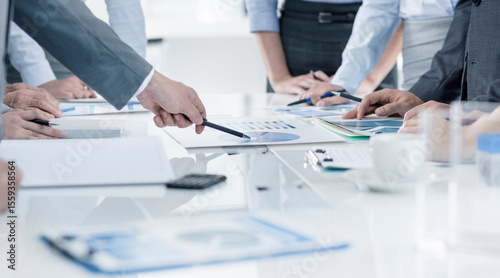 Business Professionals Analyzing Financial Reports During Corporate Meeting