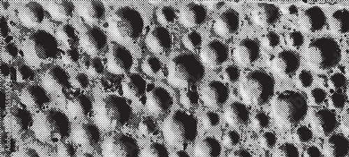 black and white halftone texture with uneven surface and round dents
