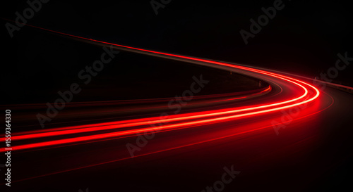 Abstract red light trails on a dark background suggesting speed and motion
