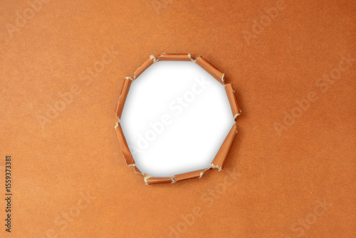 Torn Brown paper with a circular hole isolated a transparent background