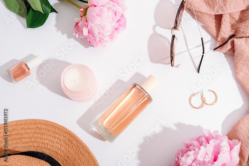 Womens flat lay cosmetics and stylish accessories, pink peony flowers on white background with sharp shadows. Beauty, fashion concept. Top view