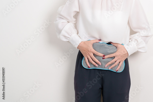 Menstruation period cycle of monthly and Stomachache concepts. woman having abdomen pain and menstrual ache with hot water bottle, illness female suffer from premenstrual ache and body Health problem