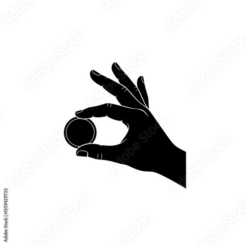 Hand holding a small round object between the thumb and index finger in a detailed view