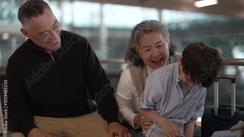 Asian multigenerational family at airport traveling with kids and grandparents, joyful moments of vacation, family holiday trip with luggage before flight, tour, friendly airline, hotel for families