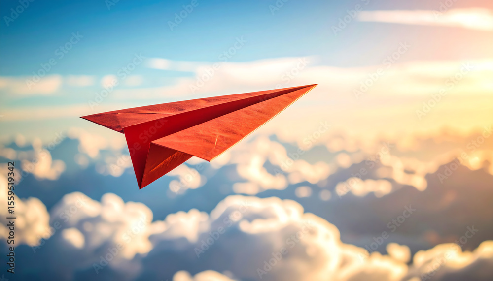 Fototapeta premium A red paper airplane soars through a bright sky filled with fluffy clouds, symbolizing freedom and imagination