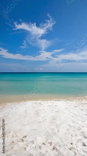 Tropical Seascape with Clear Turquoise Water and White Sand Beach under Blue Sky with Wispy Clouds