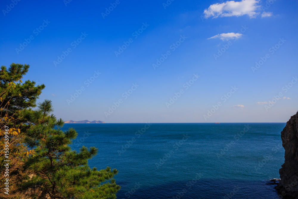 Fototapeta premium Calm blue sea and seaside rocks