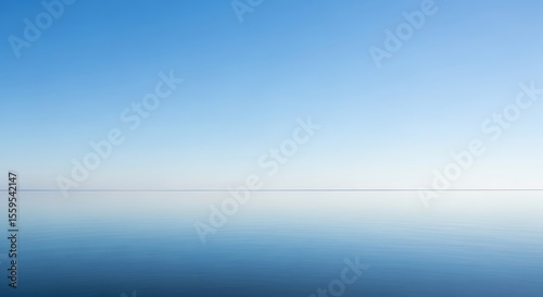 Endless horizon line meeting the sky reflected on a serene sea surface