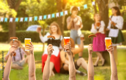 Hands with glasses of beer ...