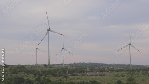 Wind turbines generate renewable energy on a cloudy day