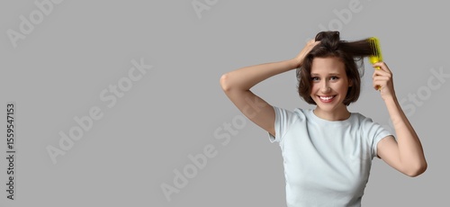 Pretty young woman brushing...