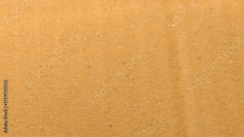 Background of brown kraft paper or cardboard texture. Old vintage paper with a glowing center and grunge vignette.