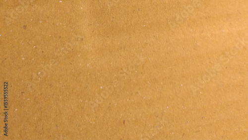 Background of brown kraft paper or cardboard texture. Abstract pattern of beige rough carton, old paper sheet, parchment or papyrus surface.